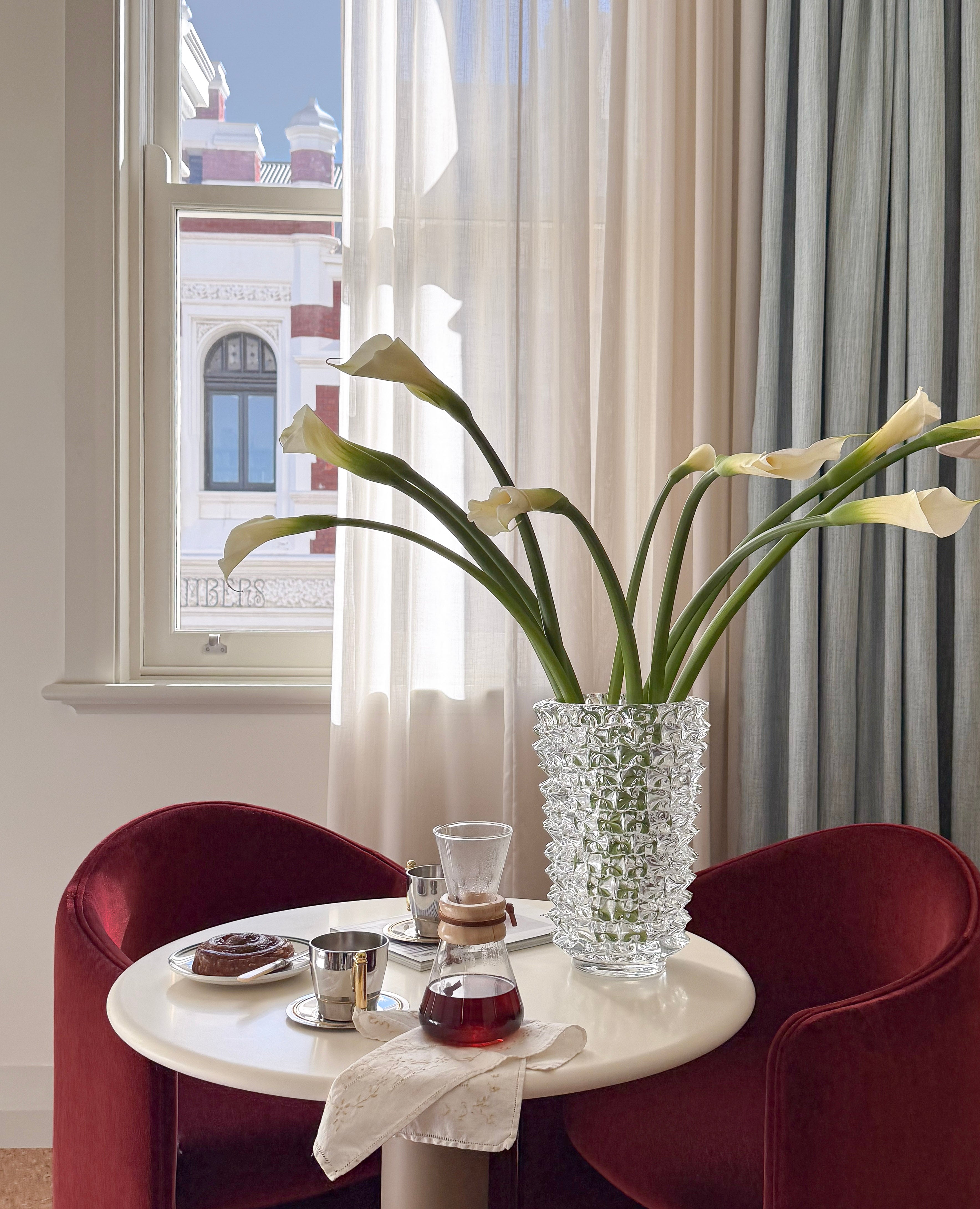 Solenne Vase in clear glass styled in a living space